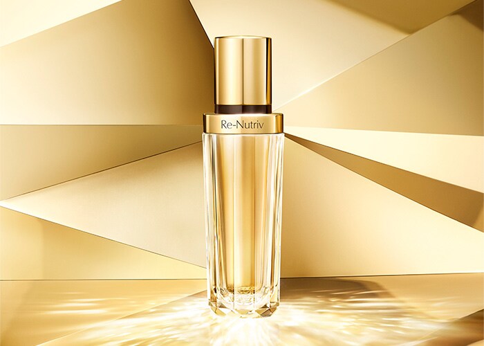 photo of woman using Re-Nutriv Diamond Brilliance Serum on skin